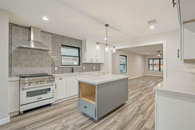 2111 Nina Lee Ln, Houston, TX 77018 - kitchen with light countertops, stainless steel range, visible vents, and wall chimney exhaust hood