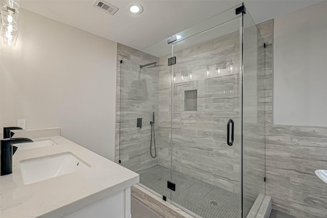 2111 Nina Lee Ln, Houston, TX 77018 - full bathroom with a sink, double vanity, visible vents, and a stall shower