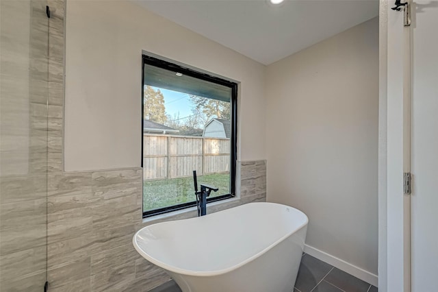 2111 Nina Lee Ln, Houston, TX 77018 - full bathroom with a freestanding bath, tile patterned floors, baseboards, and tile walls