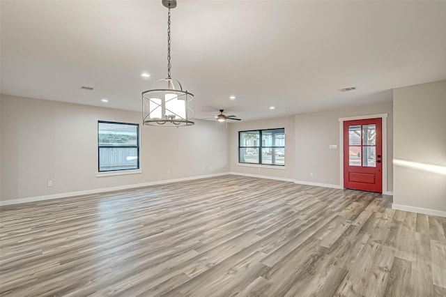 2111 Nina Lee Ln, Houston, TX 77018 - unfurnished living room featuring light wood-style flooring, plenty of natural light, baseboards, and visible vents