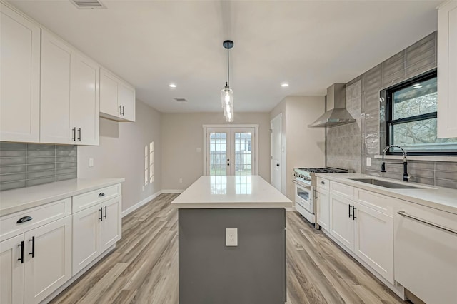 2111 Nina Lee Ln, Houston, TX 77018 - kitchen with high end stainless steel range, a sink, a kitchen island, wall chimney range hood, and decorative backsplash
