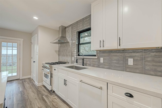 2111 Nina Lee Ln, Houston, TX 77018 - kitchen featuring wall chimney range hood, a sink, light countertops, and stainless steel stove