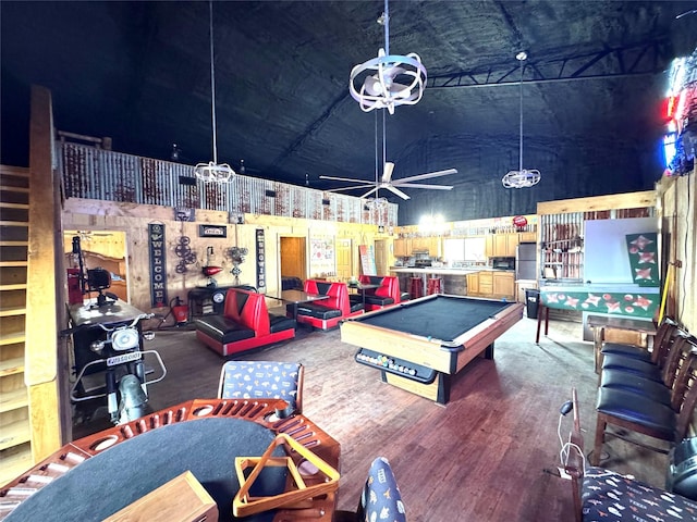 rec room featuring a towering ceiling, a ceiling fan, wood finished floors, and pool table