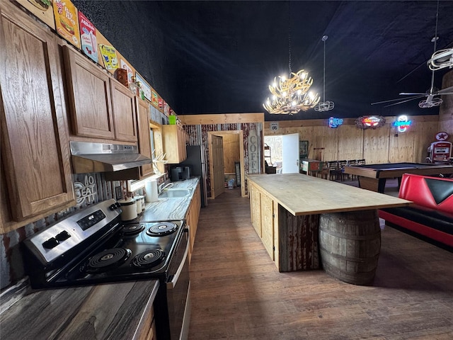 kitchen featuring dark wood-style floors, electric range, a sink, wood counters, and under cabinet range hood