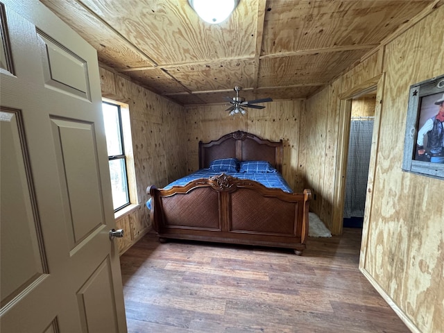 bedroom featuring wood ceiling, wooden walls, and wood finished floors