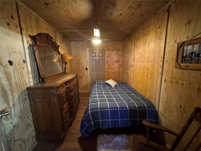 bedroom featuring dark wood-style floors and wooden ceiling