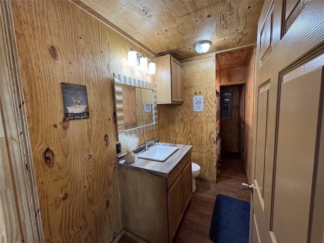 half bath with wooden ceiling, toilet, wood walls, wood finished floors, and electric panel