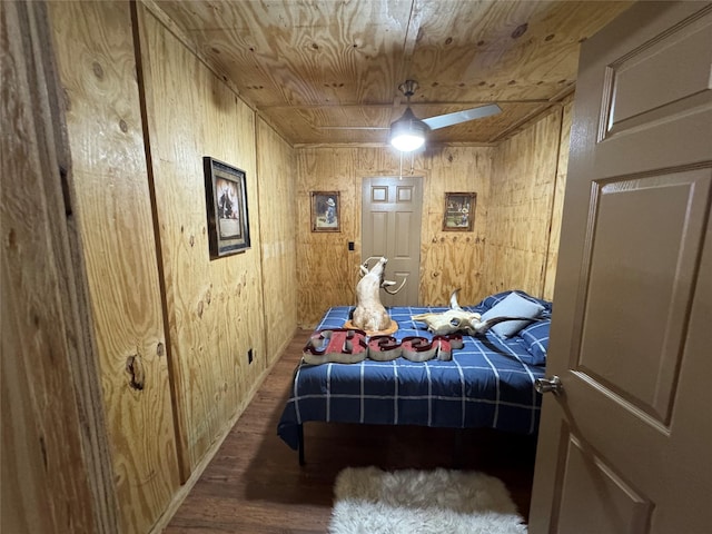 bedroom with wooden ceiling, wood finished floors, and wooden walls