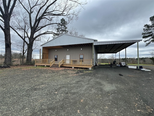 view of front of house with driveway and a wooden deck