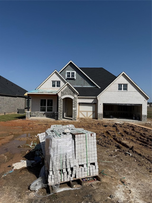 view of front of home featuring a garage and brick siding