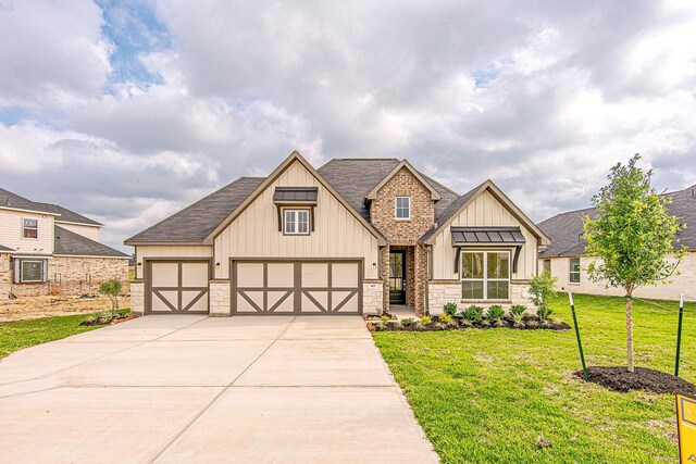 187 Peninsula Point Dr, Montgomery, TX 77356 - view of front of house with board and batten siding, a front yard, driveway, roof with shingles, and stone siding