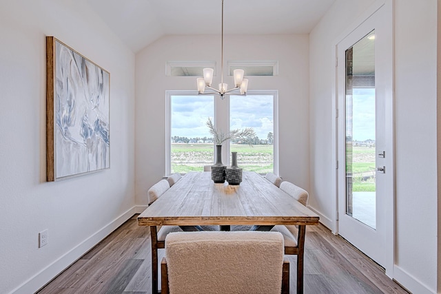 187 Peninsula Point Dr, Montgomery, TX 77356 - dining room featuring a chandelier, plenty of natural light, lofted ceiling, and wood finished floors
