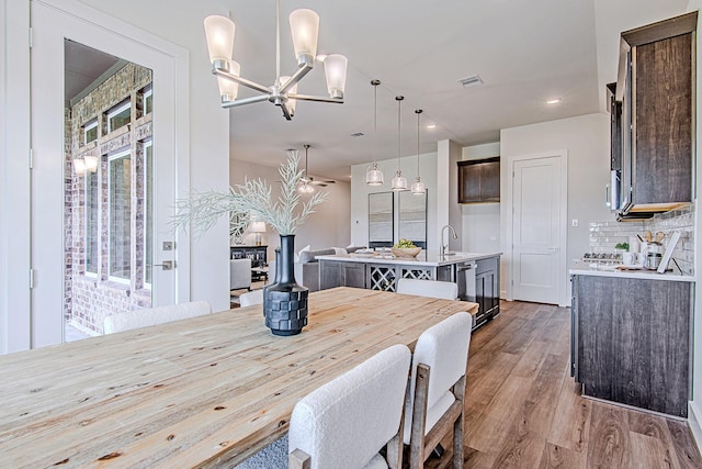 187 Peninsula Point Dr, Montgomery, TX 77356 - dining room featuring light wood-style flooring and a chandelier