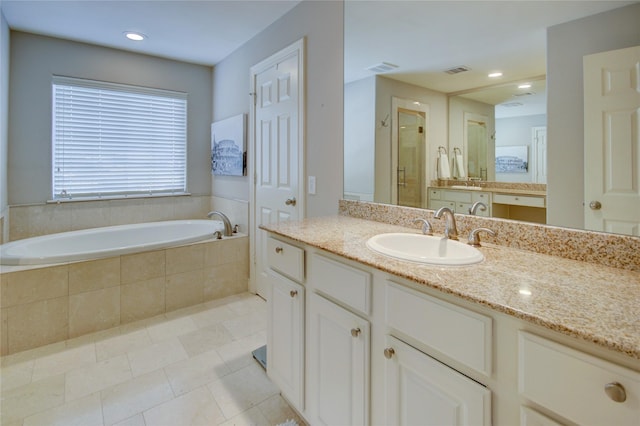 full bathroom featuring visible vents, a stall shower, vanity, and a garden tub