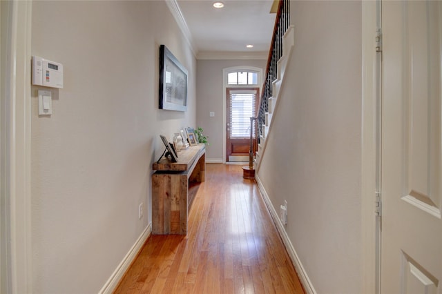 doorway with recessed lighting, stairway, crown molding, light wood finished floors, and baseboards