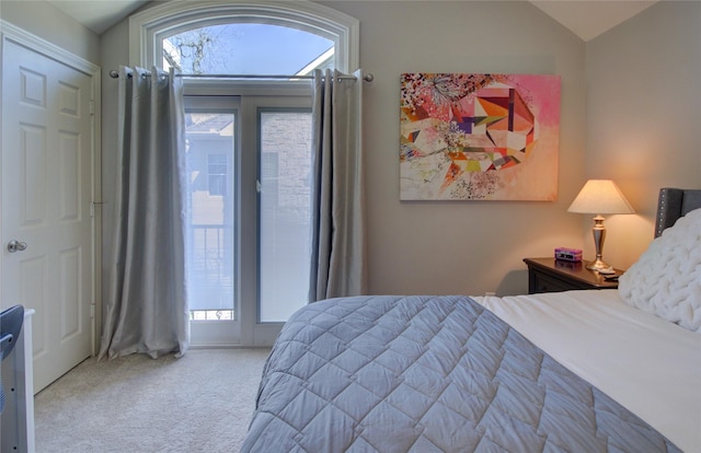 carpeted bedroom featuring access to exterior and vaulted ceiling