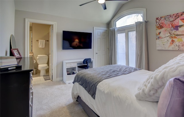 bedroom with connected bathroom, baseboards, lofted ceiling, light carpet, and a ceiling fan