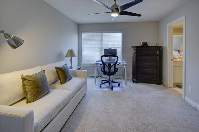 carpeted home office featuring ceiling fan and baseboards