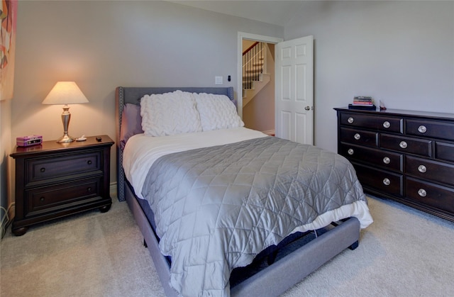 bedroom featuring light carpet