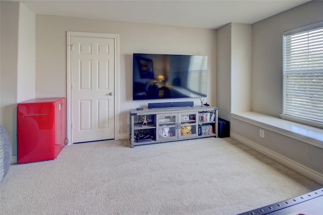 living room with carpet and baseboards