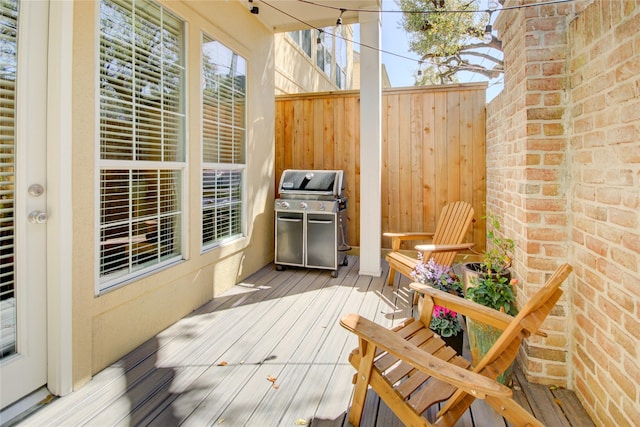 deck featuring a grill and fence