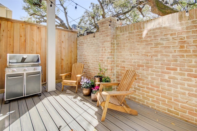 deck featuring a grill and fence