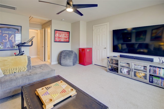 living area featuring visible vents, carpet flooring, baseboards, and a ceiling fan