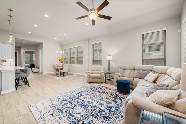 living area featuring ceiling fan, light wood-style floors, baseboards, and recessed lighting