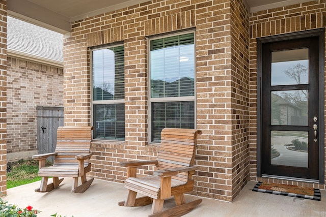 doorway to property with brick siding