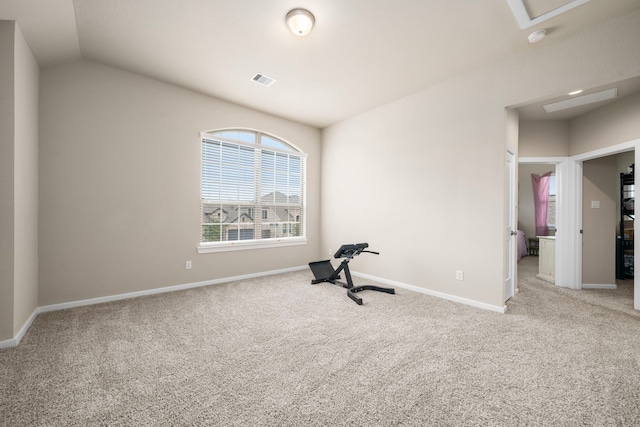 workout room with lofted ceiling, carpet flooring, visible vents, and baseboards