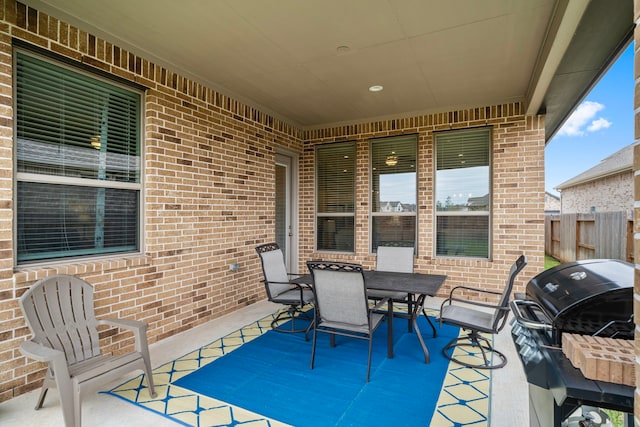 view of patio / terrace featuring grilling area, fence, and outdoor dining area