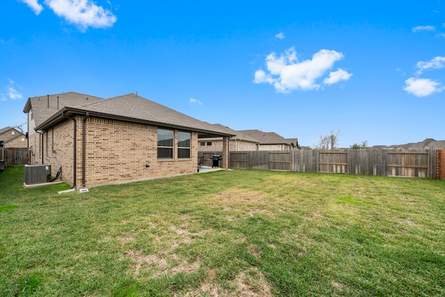 view of yard featuring central AC unit, a patio area, and a fenced backyard