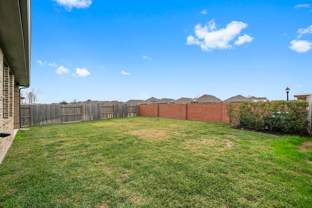 view of yard with a fenced backyard