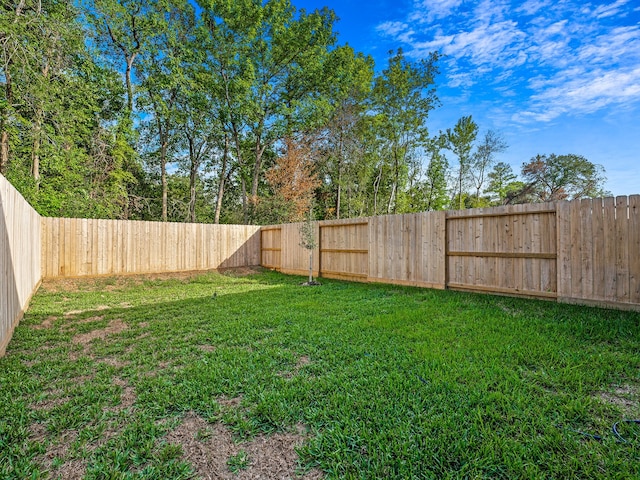 view of yard with a fenced backyard