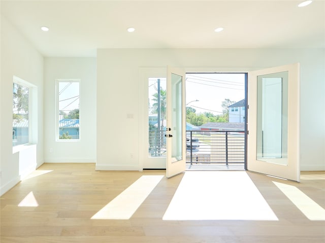 entryway featuring light wood-type flooring, french doors, plenty of natural light, and recessed lighting