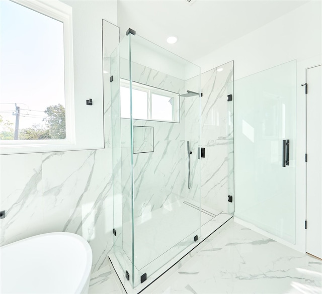 full bath featuring marble finish floor, recessed lighting, a marble finish shower, and a soaking tub