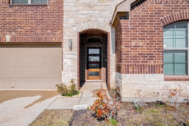 view of exterior entry with stone siding and brick siding