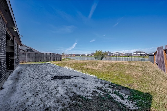 view of yard with a residential view and a fenced backyard