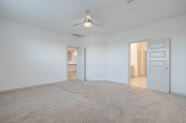 unfurnished bedroom with light carpet, ensuite bath, baseboards, and visible vents