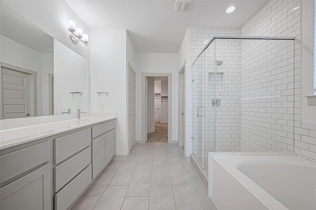 full bath with tile patterned floors, a shower stall, a bath, and vanity