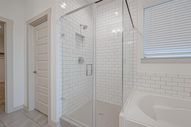 bathroom featuring a garden tub, tile patterned flooring, and a stall shower