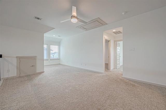 spare room featuring attic access, carpet, visible vents, and baseboards