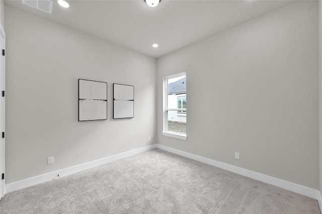 carpeted empty room featuring recessed lighting, visible vents, and baseboards