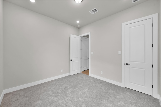 unfurnished bedroom with carpet floors, recessed lighting, visible vents, and baseboards