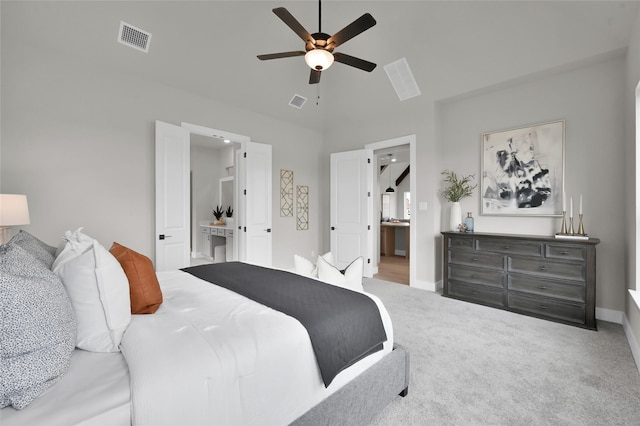 bedroom with ensuite bathroom, carpet, visible vents, and baseboards