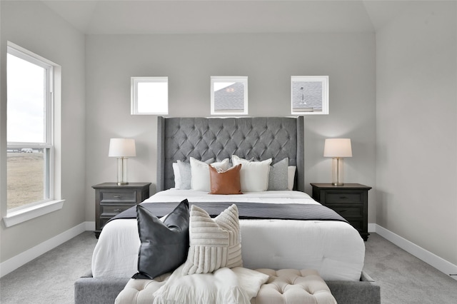 bedroom with baseboards and light colored carpet