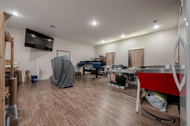 interior space with recessed lighting, visible vents, and wood finished floors