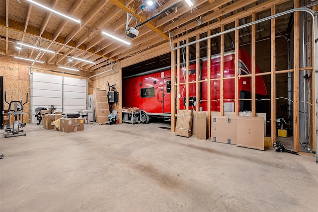 garage with a garage door opener and electric panel