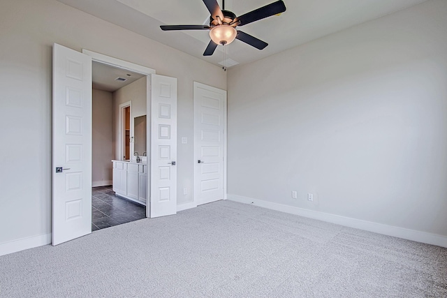 141 Peninsula Point Dr, Montgomery, TX 77356 - unfurnished bedroom with baseboards, dark colored carpet, a ceiling fan, and a sink