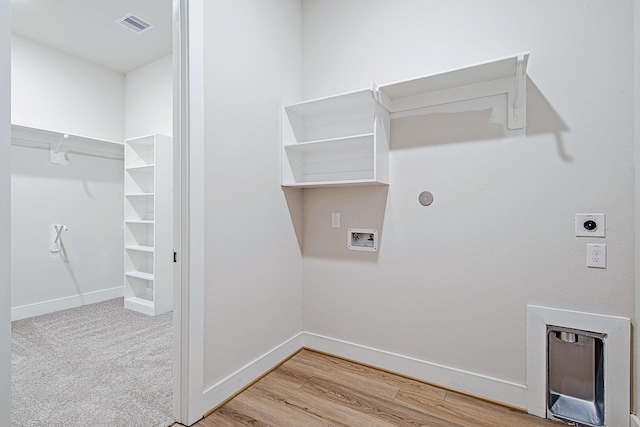 141 Peninsula Point Dr, Montgomery, TX 77356 - laundry area with hookup for an electric dryer, hookup for a washing machine, light wood finished floors, and baseboards